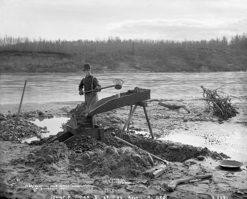 Historic photo of a gold panner using a sluice box.