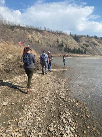 Members of Quaternary Palaeontology walk along the river bank.