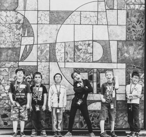 Photo of six children standing in front of the RAM building.